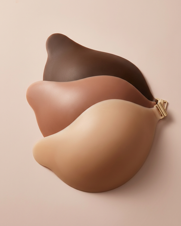 Adhesive bra cups shown alongside a backless dress for styling context