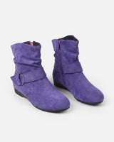 Close-up of adjustable buckle strap on suede-effect ankle boot