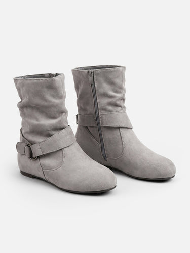 Ankle boots worn with jeans, showing relaxed silhouette at ankle