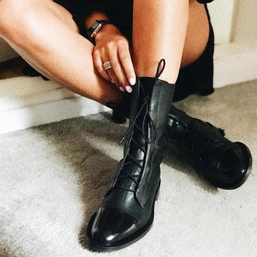 Pair of lace-up leather ankle boots laid flat, top-down view