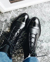 Overhead view of lace-up leather ankle boots on flat surface