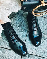 Three-quarter view of leather ankle boots showing toe shape