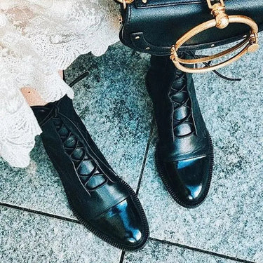 Three-quarter view of leather ankle boots showing toe shape