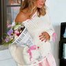 Side view showing the asymmetrical hemline of the jumper