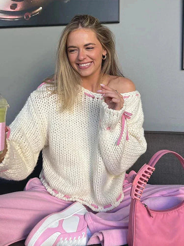 Model wearing the asymmetrical jumper in pink with trousers