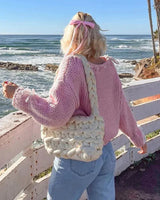 Rear view of the relaxed-fit asymmetrical jumper in black