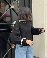 Full-length shot of the jumper styled with casual bottoms