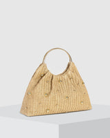 Side profile of the beaded straw hobo bag showing its rounded silhouette and depth