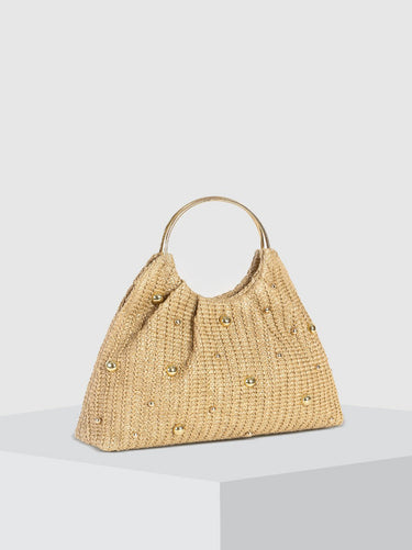 Side profile of the beaded straw hobo bag showing its rounded silhouette and depth