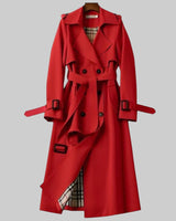 Side view showing the longline silhouette and belted waist of the trench coat