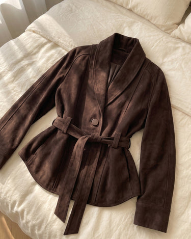 Close-up of the suede texture and hem finish on the jacket