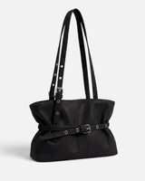 Side view showing the billowing shape and long shoulder handles of the tote bag