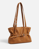 Front view of a belted tote bag with a gathered silhouette and slim front buckle strap