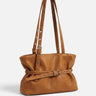 Front view of a belted tote bag with a gathered silhouette and slim front buckle strap