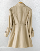 Front view of a longline belted trench coat with notched collar and buttoned cuffs