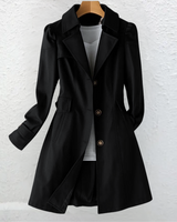 Side view showing the mid-length silhouette and belted waist of the trench coat