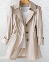 Back view of the longline trench coat showing structured shoulders and straight-cut hem
