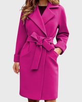 Front view of a belted long-sleeve trench coat with structured lapel collar