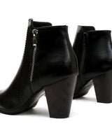Side profile of ankle boots showing block heel and zip detail