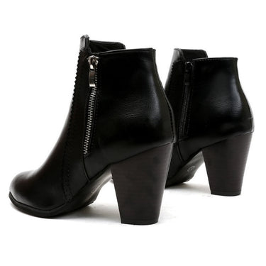 Side profile of ankle boots showing block heel and zip detail