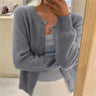 Close-up of button-front closure on a hip-length knit cardigan