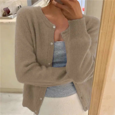 Styled shot of button-front cardigan worn open over a camisole