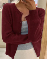 Close-up of the round neckline and fine knit texture of the cardigan