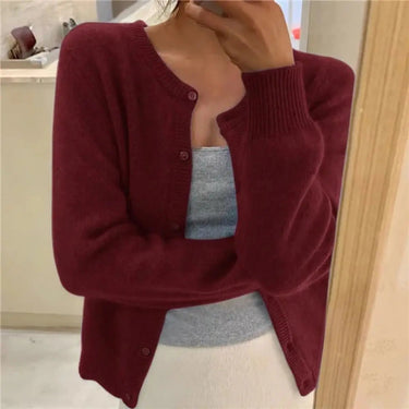 Close-up of the round neckline and fine knit texture of the cardigan