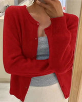Full-length view of the button-front cardigan styled with tailored trousers