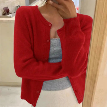 Full-length view of the button-front cardigan styled with tailored trousers