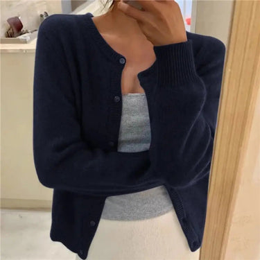 Front view of a button-front knit cardigan with round neckline and ribbed cuffs