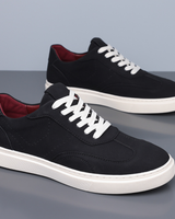 Men's low top trainer with lace-up closure and flat sole, side view