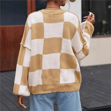 Side view of the checked jumper highlighting the straight hem and sleeve length