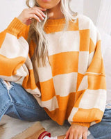 Checked jumper in light pink displayed on a model in a casual setting