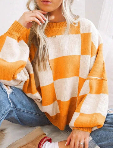Checked jumper in light pink displayed on a model in a casual setting