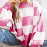 Flat lay of the checked jumper in black showing full length and sleeve detail