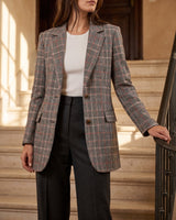 Flat lay of the checked wool blazer on a neutral background