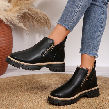 Side profile of ankle boot showing contrast stitching along the midsole