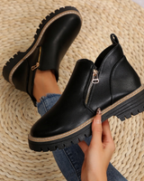 Close-up of diagonal gold zip detail across the front of the boot