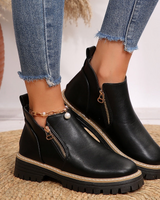 Chunky ankle boot with diagonal gold-tone zip and lug sole, front view