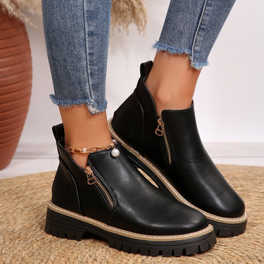 Chunky ankle boot with diagonal gold-tone zip and lug sole, front view