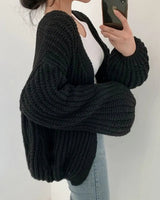 Front view of longline chunky knit cardigan with open front and ribbed texture