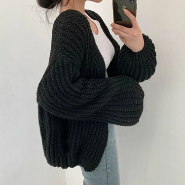 Front view of longline chunky knit cardigan with open front and ribbed texture