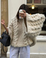 Side view of oversized knit cardigan showing dropped shoulder and sleeve detail
