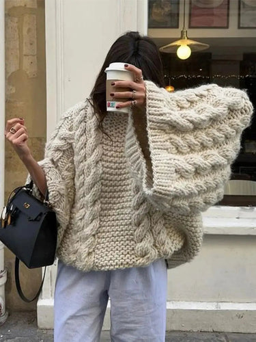 Side view of oversized knit cardigan showing dropped shoulder and sleeve detail
