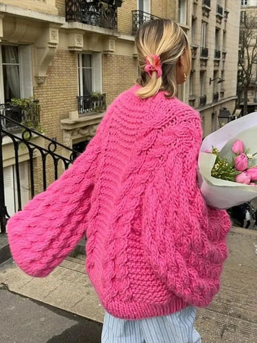 Close-up of bold cable-knit texture on women's open-front cardigan