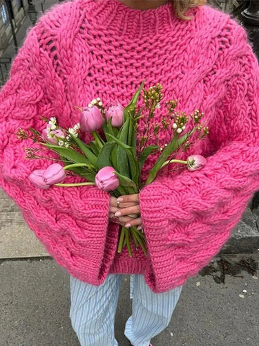 Women's chunky knit cardigan styled with jeans and ankle boots
