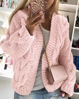 Chunky knit cardigan showing cable texture detail at close range