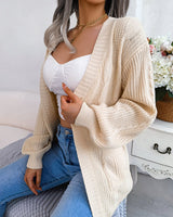 Side view showing batwing sleeves and relaxed silhouette of cable knit cardigan