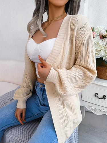 Side view showing batwing sleeves and relaxed silhouette of cable knit cardigan